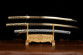 Sword on a wooden stand against a black background